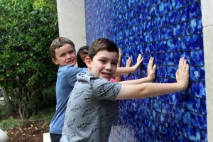 Boys Playing in the Water Wall